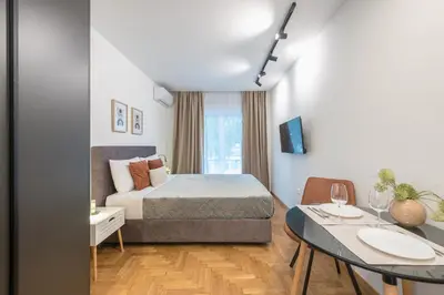 a hotel room with a bed and a table at Athens Home in Athens