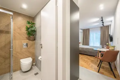 a bathroom with a shower and a toilet and a table at Athens Home in Athens