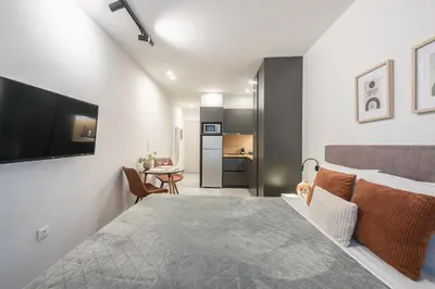 a bedroom with a bed and a living room at Athens Home in Athens