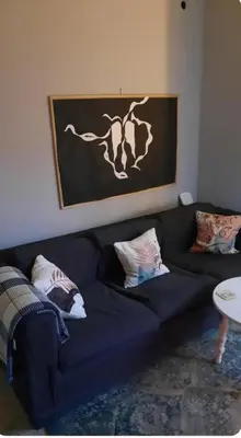 a black couch with pillows on it in a living room at Cozy Penthouse in Athens Center in Athens