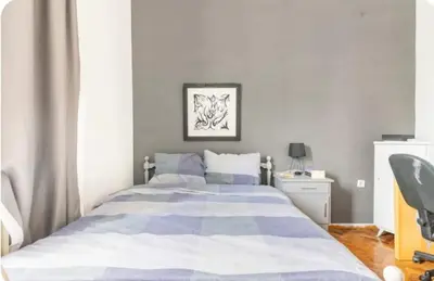 a bedroom with a large bed and a desk at Cozy Penthouse in Athens Center in Athens