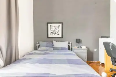 a bedroom with a large bed and a desk at Cozy Penthouse in Athens Center in Athens