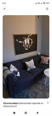 a living room with a blue couch with pillows at Cozy Penthouse in Athens Center in Athens