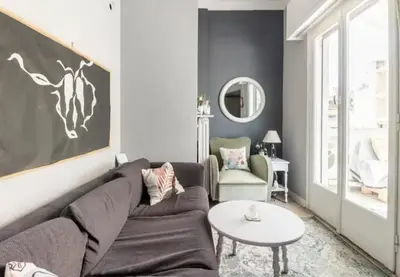 a living room with a couch and a table at Cozy Penthouse in Athens Center in Athens