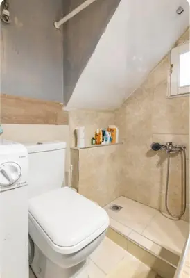 a bathroom with a toilet and a shower at Cozy Penthouse in Athens Center in Athens