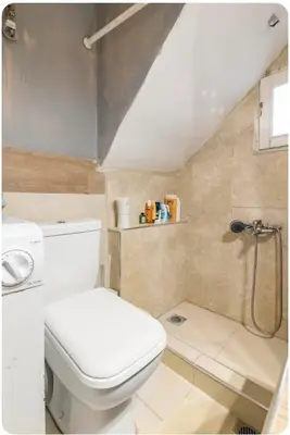 a bathroom with a toilet and a shower at Cozy Penthouse in Athens Center in Athens