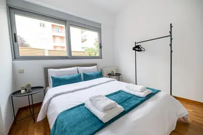 a bedroom with a large bed with two towels on it at Chic 1BR Apartment in Neo Psichiko in Athens