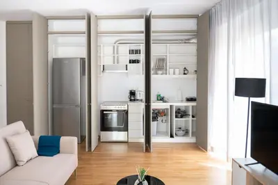 a living room with a couch and a kitchen at Chic 1BR Apartment in Neo Psichiko in Athens