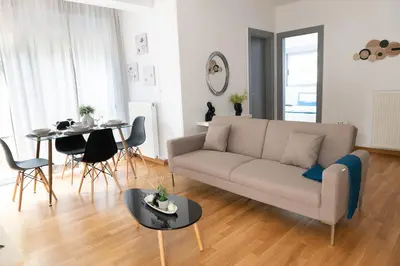 a living room with a couch and a table at Chic 1BR Apartment in Neo Psichiko in Athens