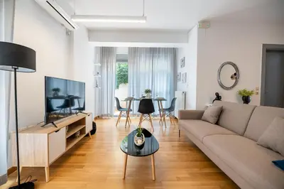 a living room with a couch and a table at Chic 1BR Apartment in Neo Psichiko in Athens