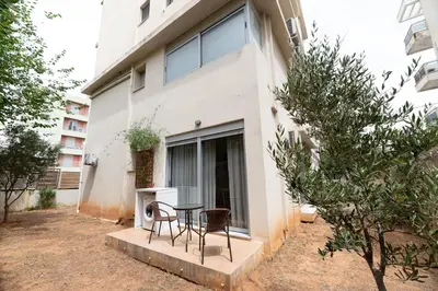 a table and chairs in front of a building at Chic 1BR Apartment in Neo Psichiko in Athens