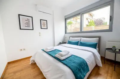 a bedroom with a large bed with towels on it at Chic 1BR Apartment in Neo Psichiko in Athens