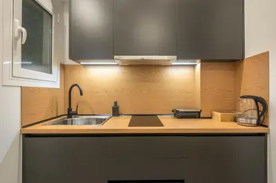 a kitchen with a sink and a counter top at Home In Athens in Athens