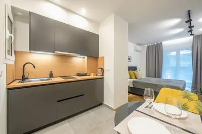 a kitchen with a sink and a bed in a room at Home In Athens in Athens