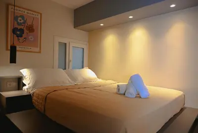 a bedroom with a bed with two towels on it at Elegant 42sqm Apartment in Lycabettus in Athens