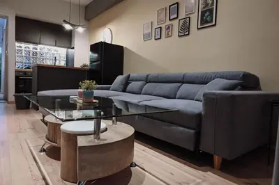 a living room with a couch and a glass table at Elegant 42sqm Apartment in Lycabettus in Athens