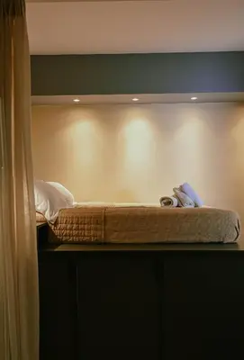 a bed sitting on a shelf in a room at Elegant 42sqm Apartment in Lycabettus in Athens
