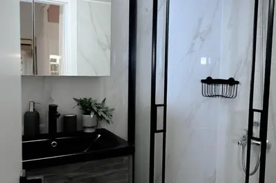 a bathroom with a sink and a mirror at Elegant 42sqm Apartment in Lycabettus in Athens