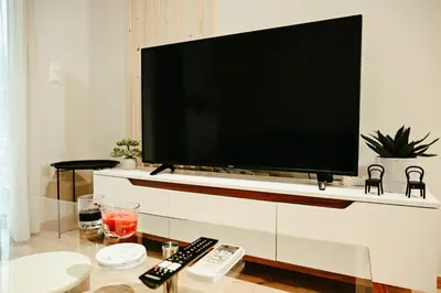 a flat screen tv on a wall in a living room at Elegant 42sqm Apartment in Lycabettus in Athens