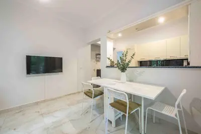 a dining room with a white table and chairs at Home In The Alimos Marina in Athens