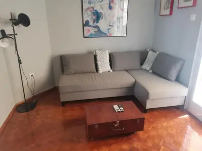 a living room with a couch and a coffee table at Υπέροχο διαμερίσμα στο κέντρο της Αθήνας in Athens