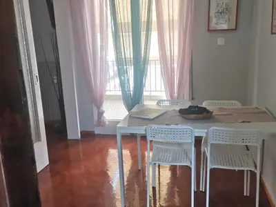 a table and chairs in a room with a window at Υπέροχο διαμερίσμα στο κέντρο της Αθήνας in Athens