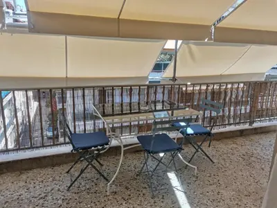 a table and chairs in front of a balcony at Υπέροχο διαμερίσμα στο κέντρο της Αθήνας in Athens