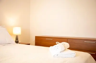 a hotel room with a towel animal on a bed at Sea La Vie in Agia Marina Aegina