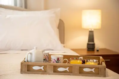 a wooden tray with cups and mugs on a bed at Sea La Vie in Agia Marina Aegina