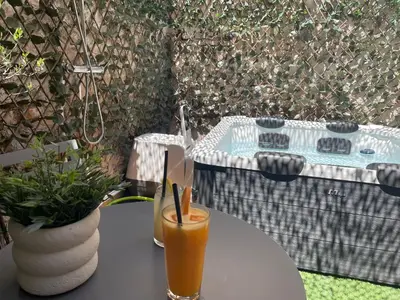 a table with a glass of juice on a table with a table at Ancient Agora Plaka in Athens