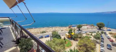 a balcony with a view of a beach and the ocean at Above the Sea in Piraeus