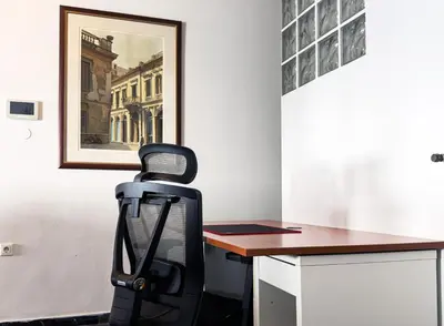 a black chair sitting in front of a desk at Above the Sea in Piraeus