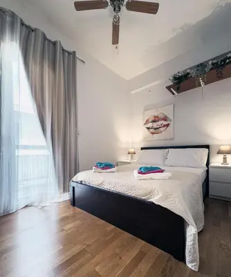 a bedroom with a bed with two towels on it at Above the Sea in Piraeus