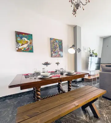a dining room with a wooden table and a bench at Above the Sea in Piraeus