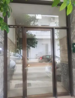 a glass door with a view of a street at Above the Sea in Piraeus