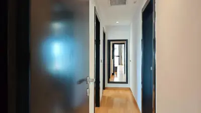 a hallway with a blue door and a mirror at Costa Voula Private Pool Penthouse by the Beach in Athens