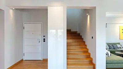 a hallway with white walls and a stairway at Costa Voula Private Pool Penthouse by the Beach in Athens