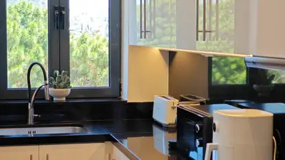 a kitchen with a sink and a counter top at Costa Voula Private Pool Penthouse by the Beach in Athens
