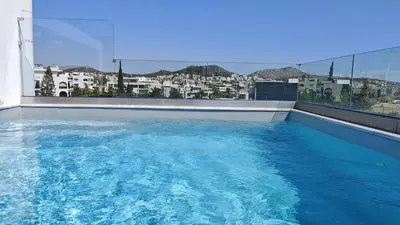 a large blue swimming pool on top of a building at Costa Voula Private Pool Penthouse by the Beach in Athens