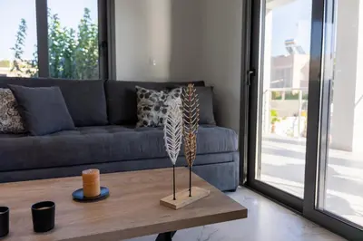 a living room with a couch and a coffee table at Mezcal Private Pool Villa in Kalívia Thorikoú