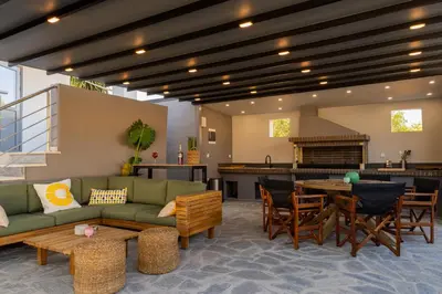 a living room with a couch and a table at Mezcal Private Pool Villa in Kalívia Thorikoú