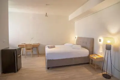 a bedroom with a bed and a desk in it at Parthenon view apt in Athens