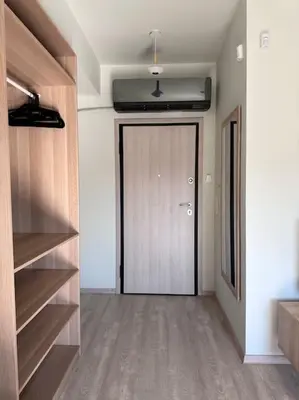a hallway with a door in a room with wooden shelves at Parthenon view apt in Athens