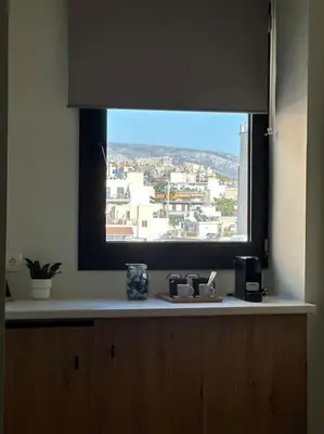 a kitchen window with a view of a city at Parthenon view apt in Athens