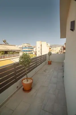 a balcony with two potted plants on a building at Parthenon view apt in Athens