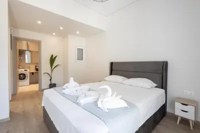 a bedroom with a bed with white towels on it at Elegance Suite Stunningly Renovated in Athens