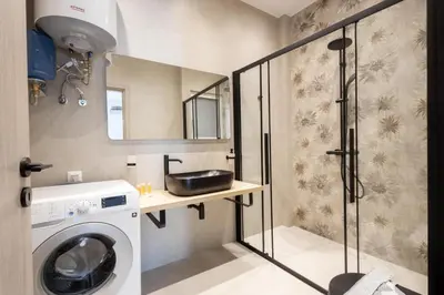 a bathroom with a washing machine and a sink at Elegance Suite Stunningly Renovated in Athens