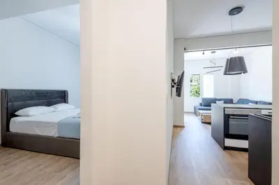 a bedroom with a bed and a living room at Elegance Suite Stunningly Renovated in Athens