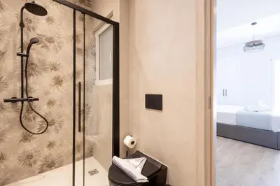 a bathroom with a shower with a glass door at Elegance Suite Stunningly Renovated in Athens