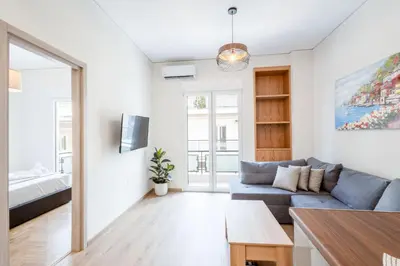 a living room with a couch and a table at Spacious 3-Bedroom Dual Apartment in City Centre in Athens